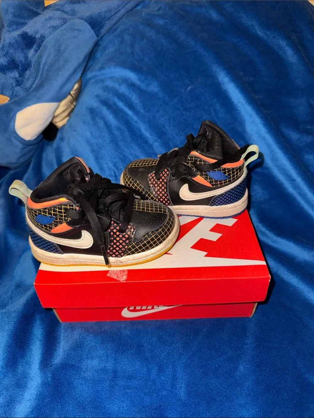 Nike Kids Black Sneakers with Blue and Orange Accents